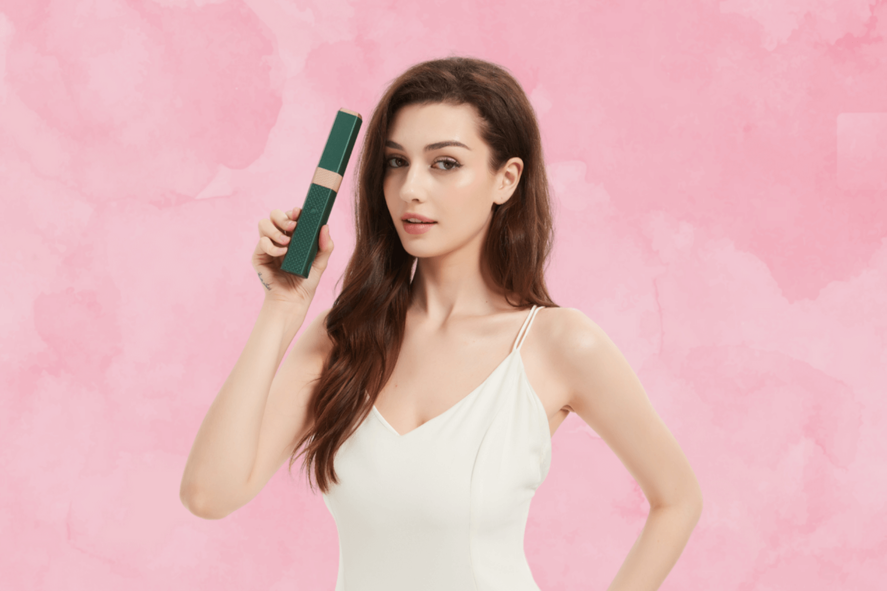 Model holding the MiniLuxe Styler cordless hair straightener and curler.