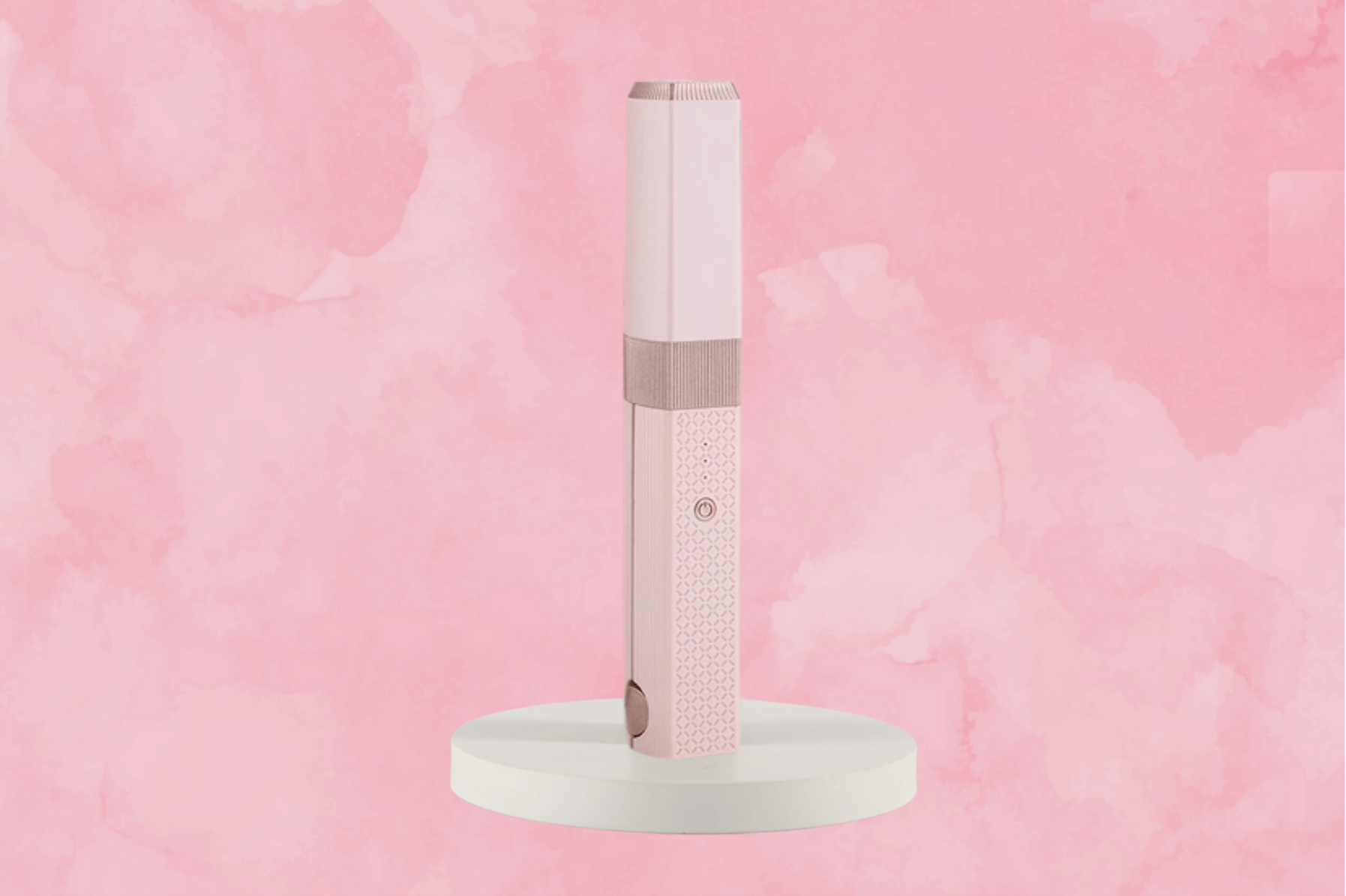 Close-up of the MiniLuxe Styler cordless hair tool in pink color.